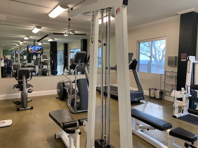 workout area featuring baseboards and ornamental molding