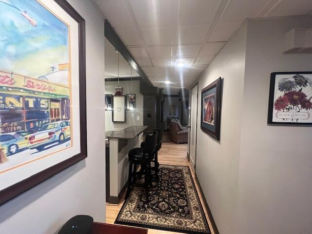 hallway with baseboards and light wood-style flooring