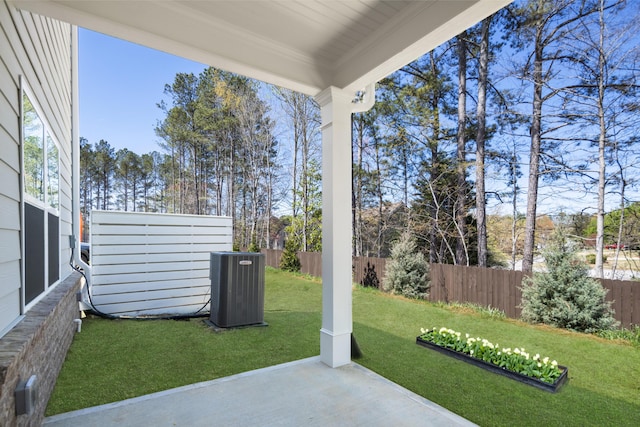 view of yard with central air condition unit, fence, and a patio area
