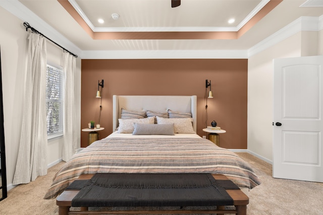 bedroom with baseboards, carpet flooring, a tray ceiling, and ornamental molding