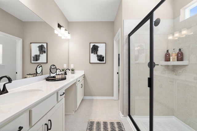 full bath featuring a shower stall, baseboards, double vanity, tile patterned floors, and a sink