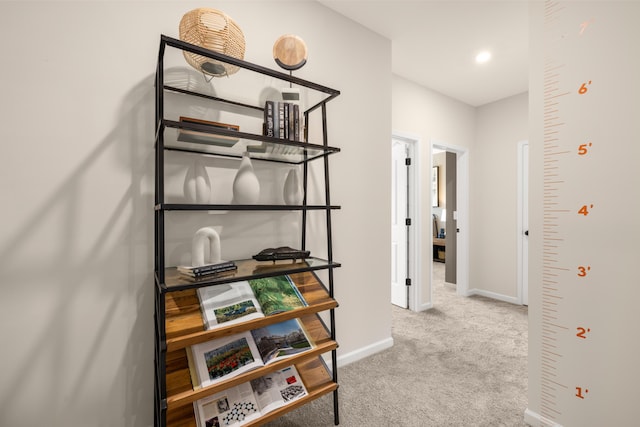 corridor featuring carpet and baseboards
