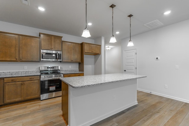 11304 Cape Vw, Soddy Daisy, TN 37379 - kitchen with stainless steel appliances, light wood finished floors, pendant lighting, light stone counters, and recessed lighting