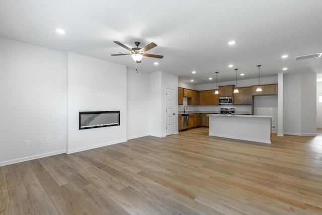 11304 Cape Vw, Soddy Daisy, TN 37379 - unfurnished living room featuring recessed lighting, ceiling fan, baseboards, light wood finished floors, and a glass covered fireplace
