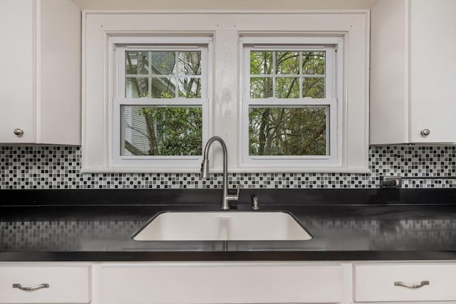 3308 Alta Vista Dr, Chattanooga, TN 37411 - kitchen with white cabinets, a sink, dark countertops, and decorative backsplash