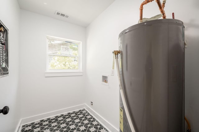 washroom featuring electric water heater, baseboards, washer hookup, visible vents, and laundry area
