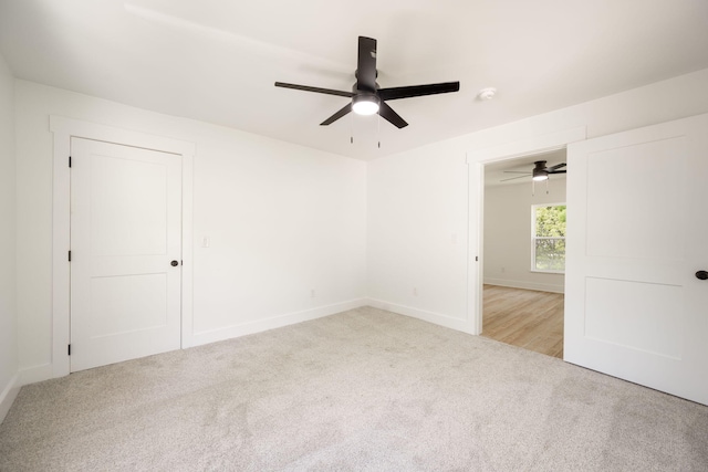 unfurnished bedroom with carpet flooring, baseboards, and a ceiling fan