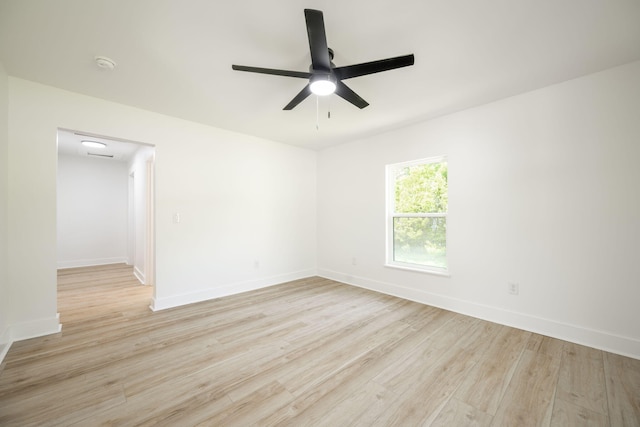 empty room with light wood-style floors, ceiling fan, and baseboards