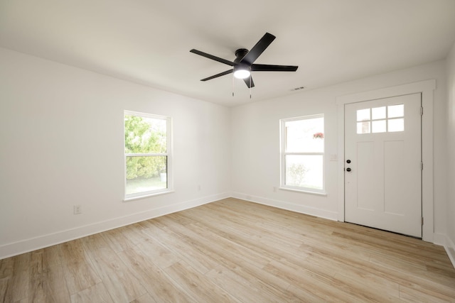 foyer entrance featuring visible vents, baseboards, ceiling fan, and light wood-style floors