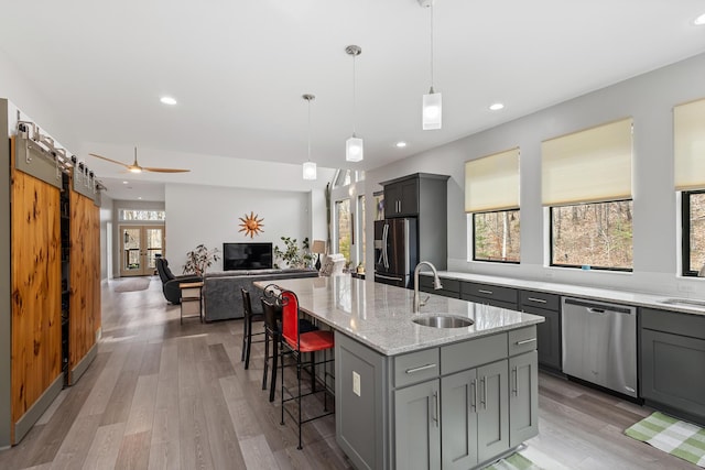 kitchen featuring a sink, appliances with stainless steel finishes, and gray cabinetry