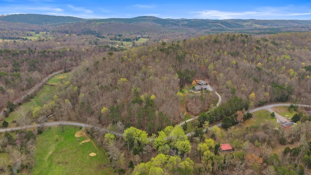 aerial view featuring a wooded view and a mountain view