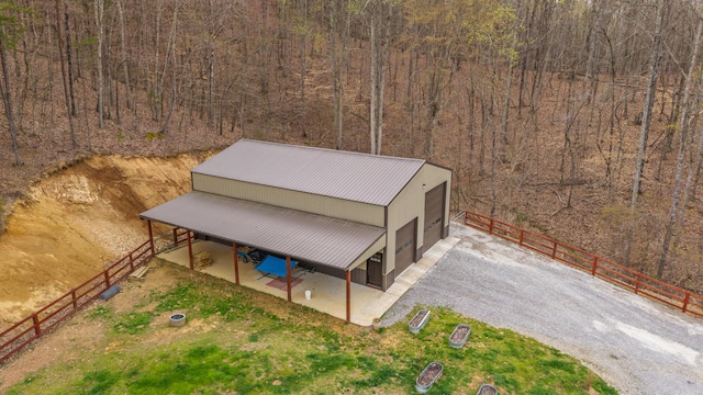 drone / aerial view featuring a wooded view