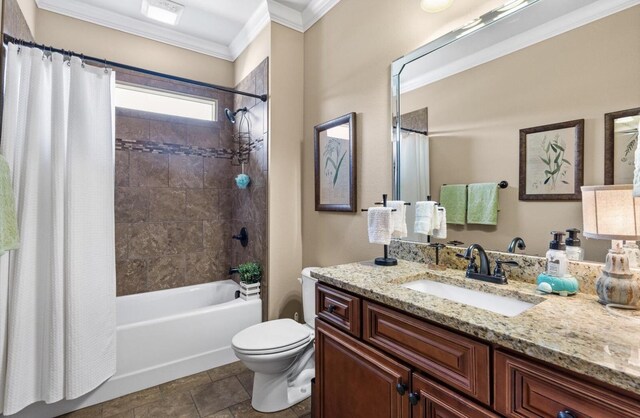 full bath featuring toilet, vanity, ornamental molding, and shower / tub combo with curtain