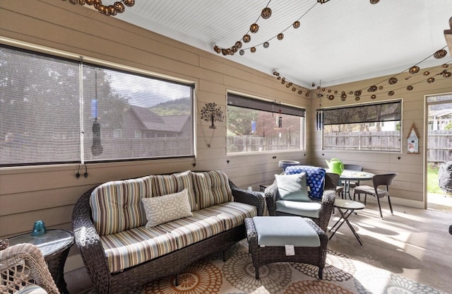 sunroom / solarium with an outdoor living space and a healthy amount of sunlight