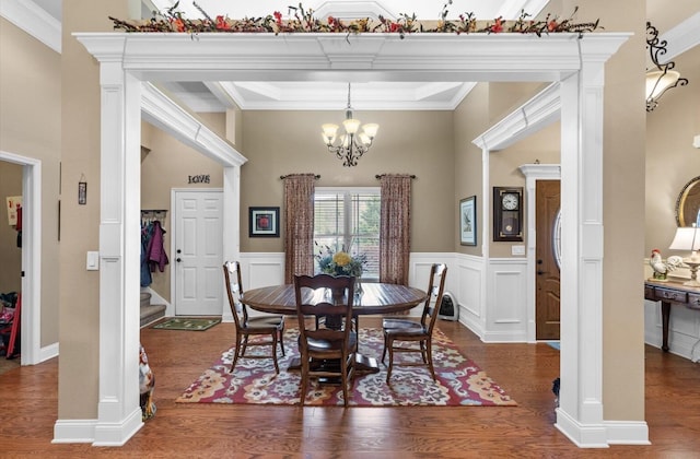 dining area featuring wainscoting, wood finished floors, stairway, and an inviting chandelier