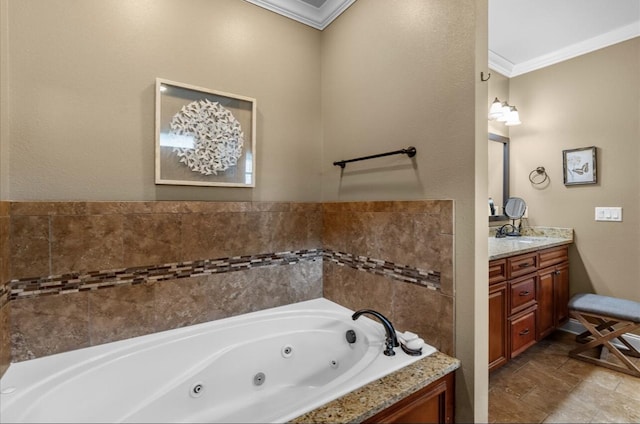 bathroom with a tub with jets, vanity, and crown molding