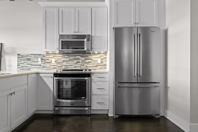 kitchen featuring backsplash, white cabinets, dark wood-style floors, and appliances with stainless steel finishes