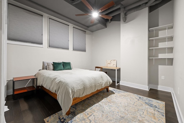 bedroom featuring baseboards and wood-type flooring
