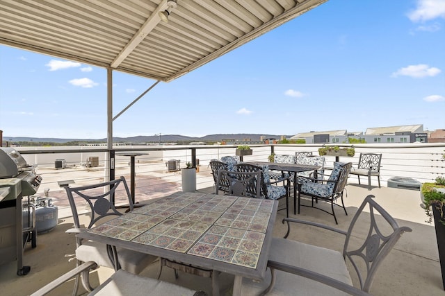 view of patio / terrace featuring outdoor dining area and a mountain view