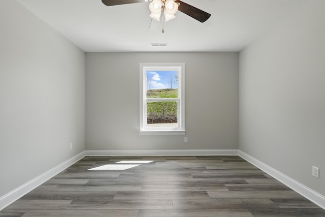 unfurnished room featuring a ceiling fan, wood finished floors, baseboards, and visible vents