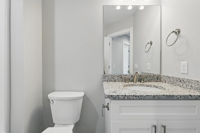 bathroom with toilet and vanity