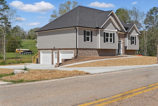 view of front of home featuring concrete driveway, a garage, and roof with shingles