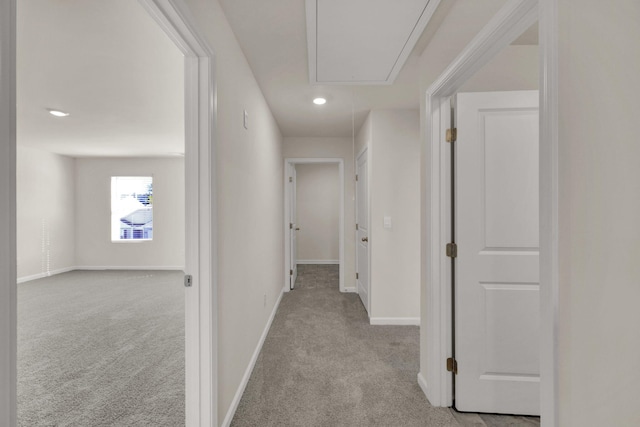 hall with baseboards, carpet floors, recessed lighting, and attic access