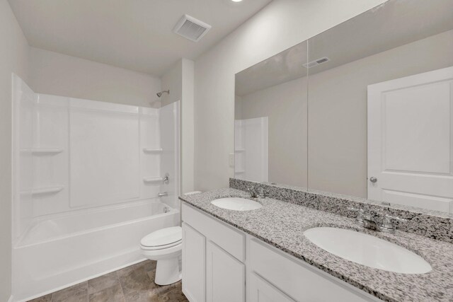 bathroom with toilet, a sink, and visible vents