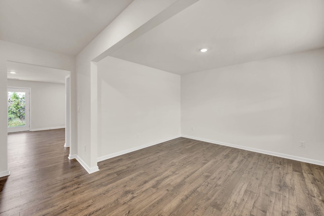 empty room with baseboards, recessed lighting, and dark wood finished floors