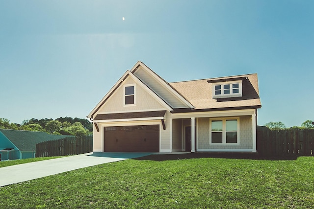view of front of home with a front lawn, fence, a garage, and driveway
