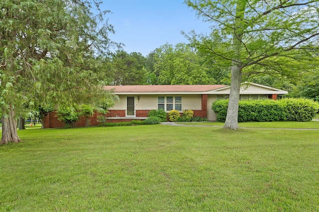 ranch-style home with a front lawn and brick siding