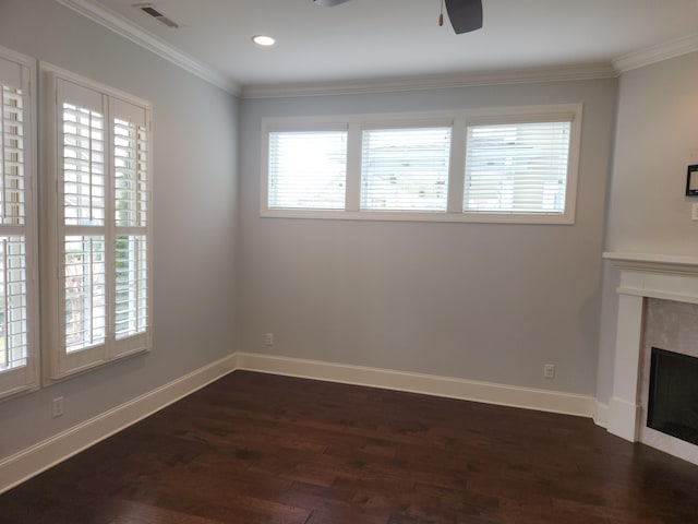 unfurnished living room with dark wood finished floors, crown molding, ceiling fan, and visible vents