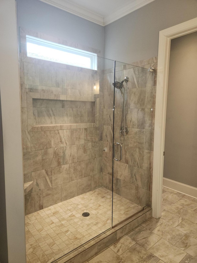 full bath featuring a shower stall, baseboards, and crown molding