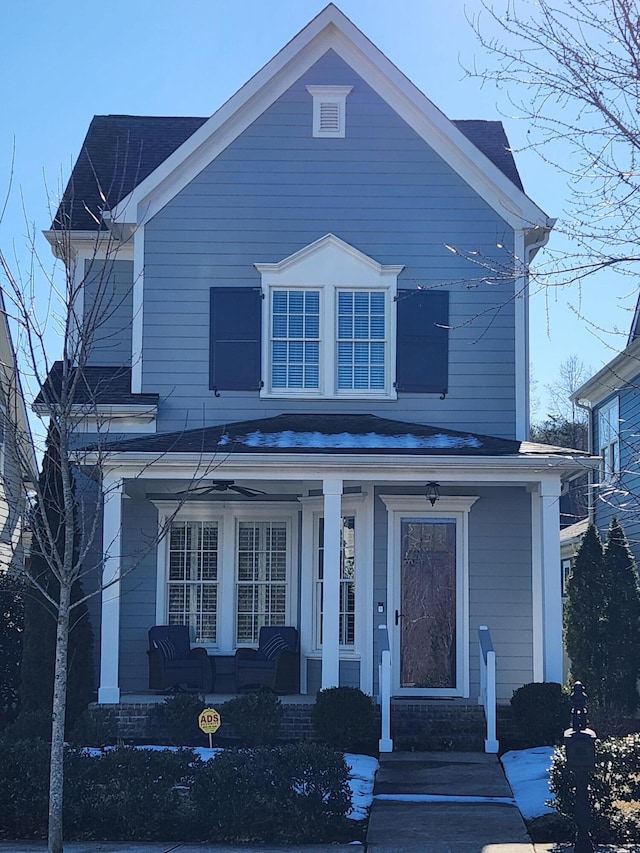 traditional-style home featuring covered porch