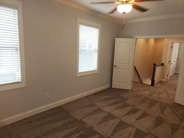 unfurnished room with a wealth of natural light, ornamental molding, and a ceiling fan