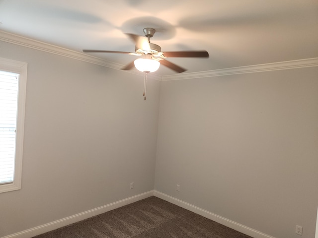 spare room featuring ornamental molding, baseboards, dark colored carpet, and ceiling fan