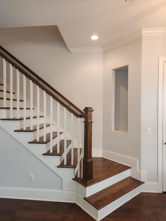 stairway featuring baseboards, ornamental molding, wood finished floors, and recessed lighting