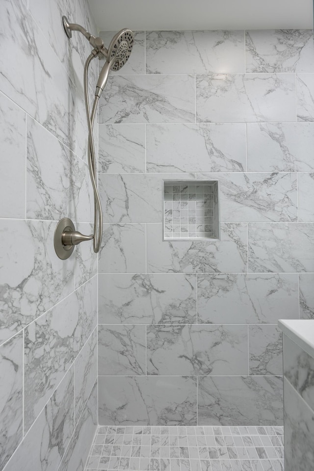 bathroom with tiled shower