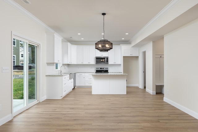 kitchen featuring light wood-style flooring, crown molding, and stainless steel appliances
