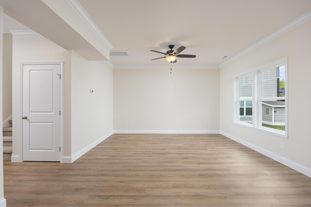 unfurnished room with baseboards, light wood-type flooring, crown molding, and ceiling fan