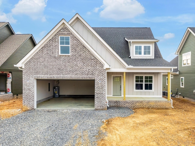 6649 Dharma Loop Unit 119, Chattanooga, TN 37412 - view of front facade featuring a garage, driveway, board and batten siding, and a shingled roof