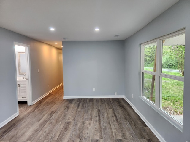 185 Carolina Ave, Delano, TN 37325 - empty room with dark wood-style flooring, baseboards, recessed lighting, and a sink