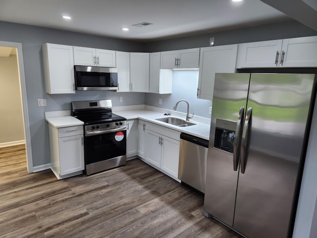 185 Carolina Ave, Delano, TN 37325 - kitchen featuring dark wood finished floors, white cabinetry, a sink, and appliances with stainless steel finishes