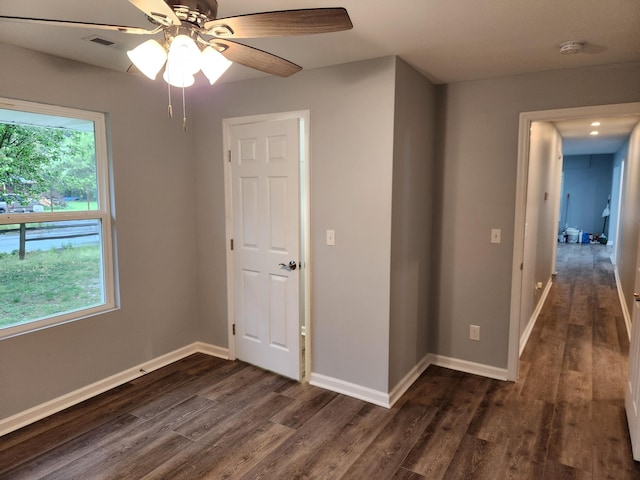 185 Carolina Ave, Delano, TN 37325 - empty room with dark wood-style flooring, visible vents, baseboards, and a ceiling fan