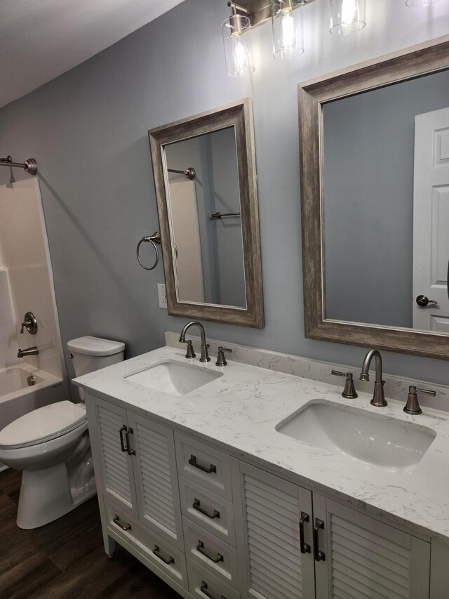 185 Carolina Ave, Delano, TN 37325 - bathroom with double vanity, a sink, toilet, and wood finished floors