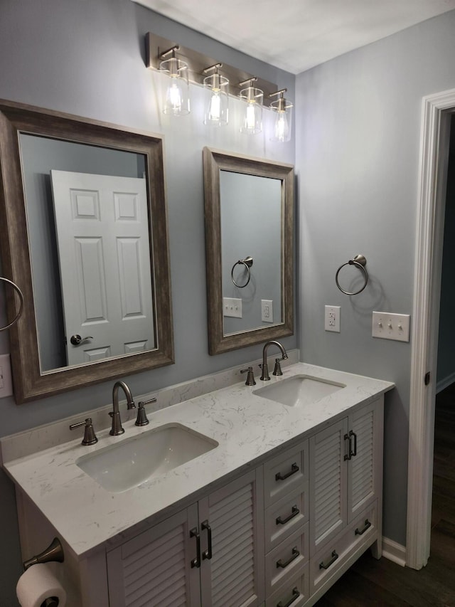 185 Carolina Ave, Delano, TN 37325 - bathroom featuring double vanity, baseboards, a sink, and wood finished floors