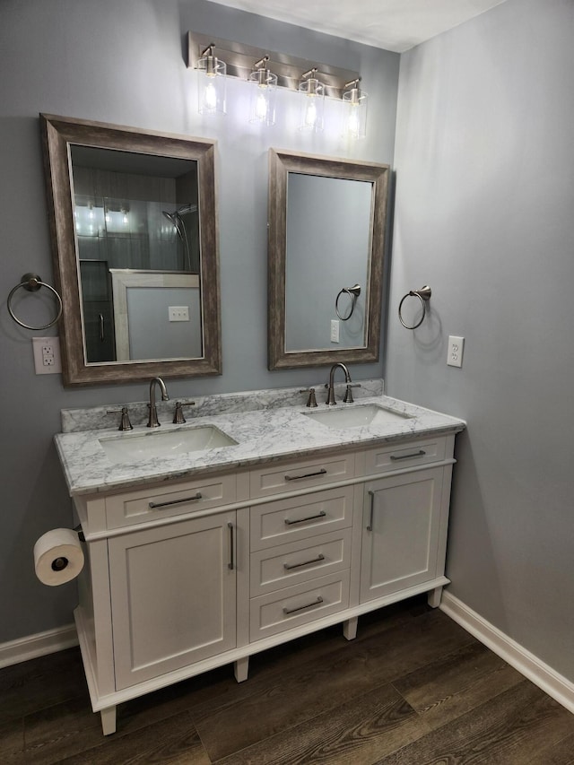 185 Carolina Ave, Delano, TN 37325 - bathroom with a sink, baseboards, double vanity, and wood finished floors