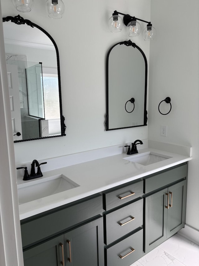 bathroom featuring double vanity, a sink, and marble finish floor