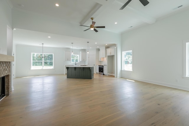 9532 N Valley Trl, Ooltewah, TN 37363 - unfurnished living room featuring ceiling fan, a brick fireplace, beam ceiling, light wood-type flooring, and baseboards