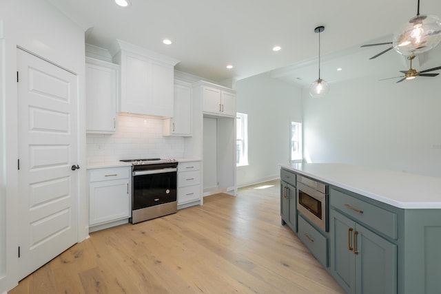 9532 N Valley Trl, Ooltewah, TN 37363 - kitchen featuring appliances with stainless steel finishes, white cabinets, backsplash, light wood-type flooring, and a ceiling fan